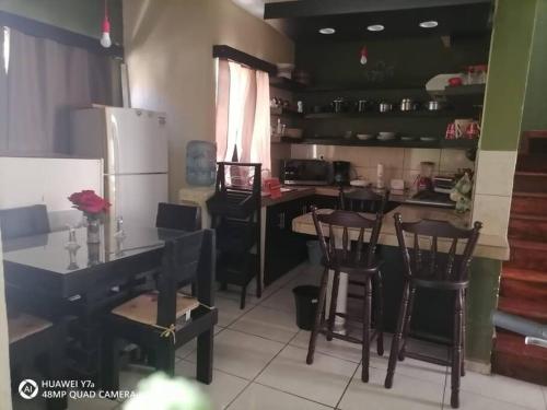 a kitchen with a table and chairs and a refrigerator at Casa Noria in Tepic