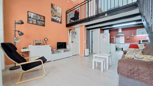 a living room with a couch and a chair at La Vaguada loft in Madrid