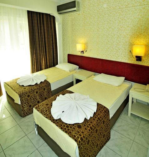 a hotel room with two beds in a room at Sun Kiss Hotel in Side