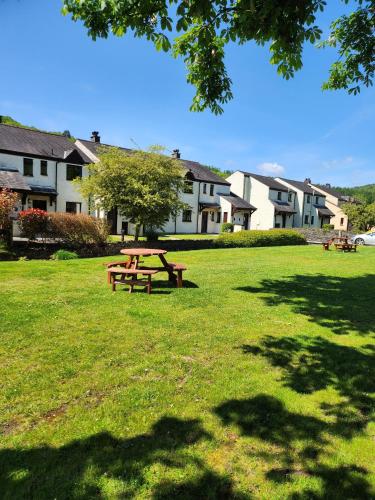 a picnic table in the grass in a park at Lakeland Village in Newby Bridge