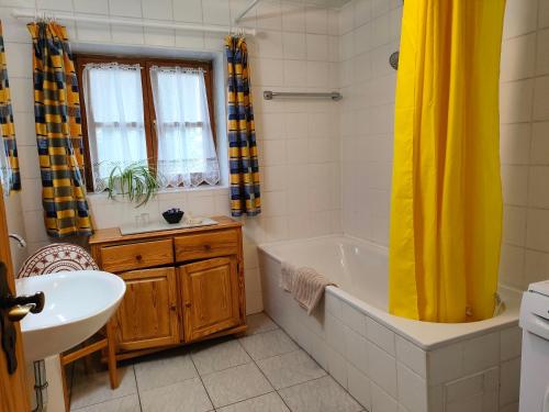 a bathroom with a tub and a sink at Schmidtler`s Nest in Warngau