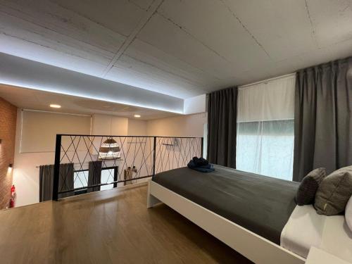 a bedroom with a large bed and a balcony at Grandera Apart`s - Carbonell 1 in Valencia