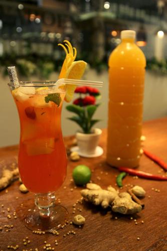 a drink sitting on a table next to a bottle of drink at Varna Culture Hotel Soerabaia in Surabaya