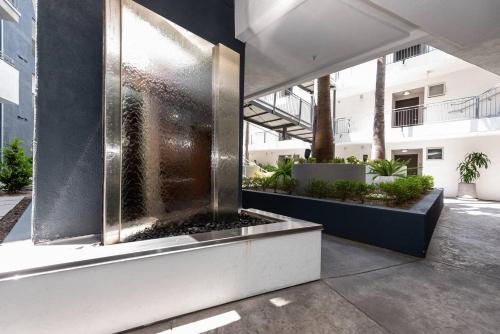 a building with a water fountain in a courtyard at Luxurious Condo Walking Distance to San Diego Bay! in San Diego