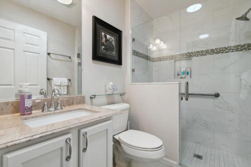 a bathroom with a toilet and a sink and a shower at Charming Villages Home with Lanai and Golf Cart! in The Villages
