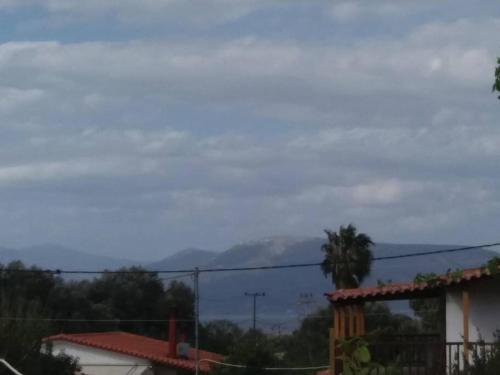 a view of the mountains from a house at Ideal Cottage Holidays-Ιδανικές Εξοχικές Διακοπές in Áyioi Apóstoloi