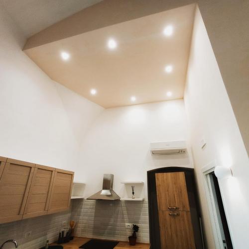 a kitchen with white walls and a ceiling at Suites Elifani Marina in Trani