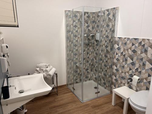 a bathroom with a shower and a sink and a toilet at La Casa di Matilde in Barcellona-Pozzo di Gotto