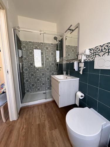 a bathroom with a shower and a toilet and a sink at La Casa di Matilde in Barcellona-Pozzo di Gotto