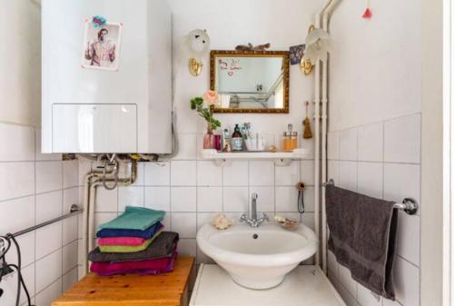 a bathroom with a sink and a mirror at MARONA - Home Studio - where Music and Art meet Business in Perchtoldsdorf
