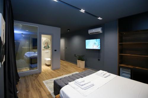 a bedroom with a bed and a tv on the wall at Seaside Apartments in Vlorë