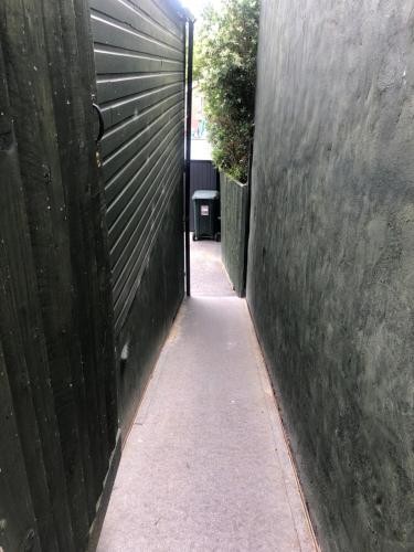 a hallway with a gate and a sidewalk at HALLSTEAD in Skegness