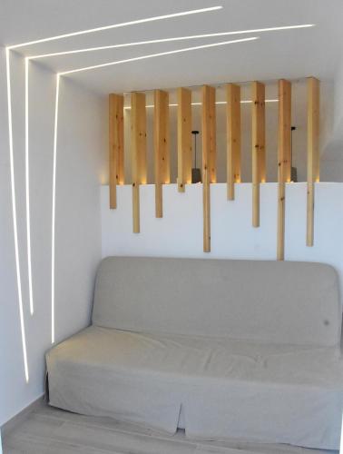 a bed in a room with wooden sticks at MNS Marvelous Nirvana Seascape, Creativity in Perani