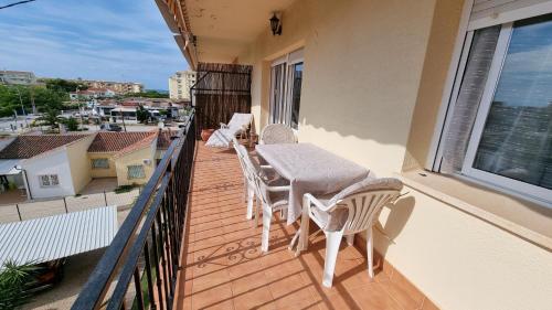 a balcony with a table and chairs on a balcony at Apartamentos La Goleta 1 in Denia