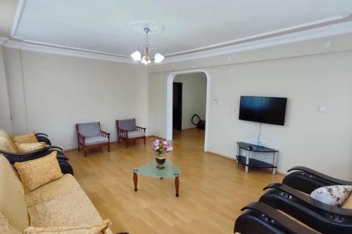 a living room with two couches and a tv at Trabzon Türkiye Kiralık Daire in Çağlayan