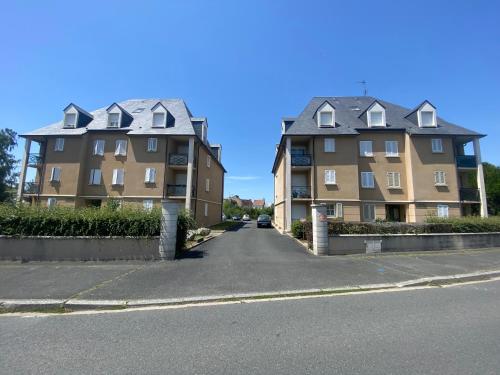 two large buildings on the side of a street at Les rives de l’Indre. Parking gratuit. Lit 160CM in Châteauroux