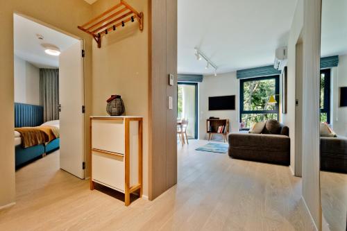 a living room with a couch and a table at Apartamenty Wydma & Las BlueApart in Jastarnia
