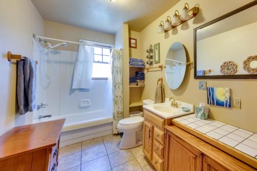 a bathroom with a toilet and a shower and a sink at Historic Colorado Springs Home with Yard in Downtown in Colorado Springs