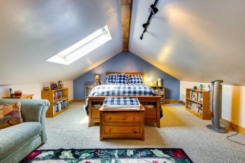 a attic bedroom with a bed and a couch at Historic Colorado Springs Home with Yard in Downtown in Colorado Springs