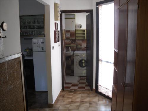 a kitchen with a washer and dryer in a room at Holiday Pool House in Pula
