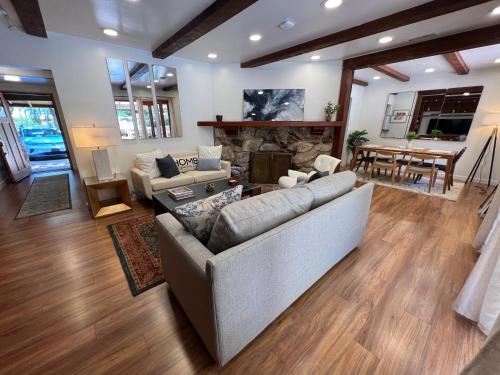 a living room with a couch and a fireplace at Villa La Reforma - Newly Designed 4BR HOUSE & POOL in Los Angeles by Topanga in Los Angeles