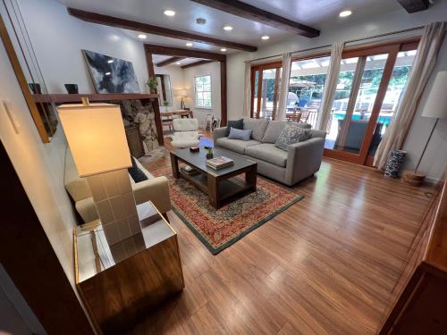 a living room with a couch and a table at Villa La Reforma - Newly Designed 4BR HOUSE & POOL in Los Angeles by Topanga in Los Angeles