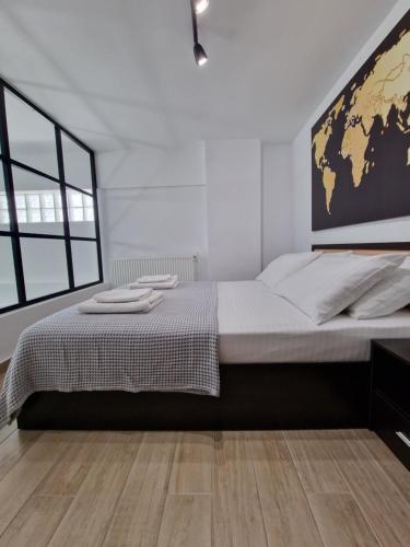 a bedroom with a large bed with a map on the wall at SKG City Loft in Thessaloniki