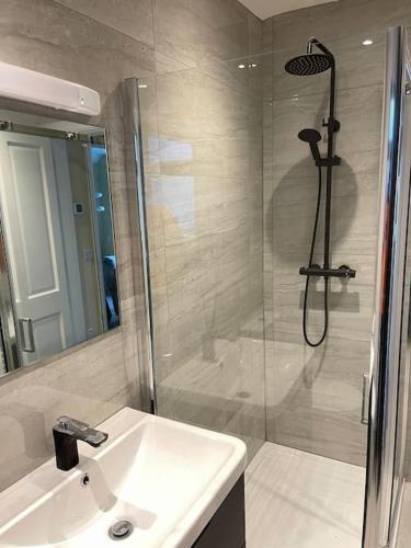 a bathroom with a sink and a shower with a shower at Heart of kinsale in Kinsale