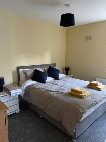a bedroom with a large bed with two towels on it at Heart of kinsale in Kinsale