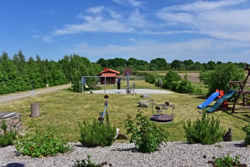 a park with a playground with a slide at Sodyba Gintaras in Priekulė
