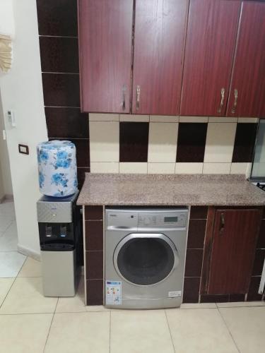 a kitchen with a washing machine and a counter at Yaso Roof & Apartments in Amman