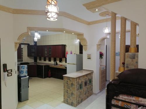 a large kitchen with a counter in a room at Yaso Roof & Apartments in Amman
