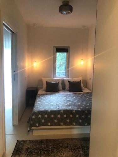 a bedroom with a large bed with a window at Apartment Lena in Čižići