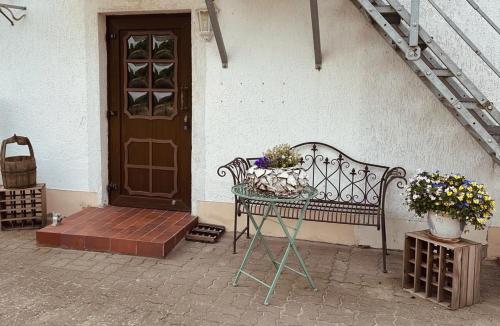 a bench sitting in front of a house with a door at Ferienwohnung Landhaus in Zurow