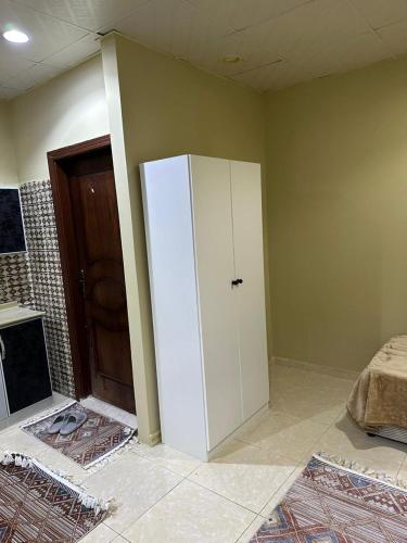 a room with a white refrigerator in a room at غرف الهدايه 