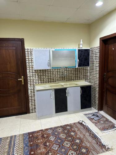 a kitchen with a sink and a microwave at غرف الهدايه 