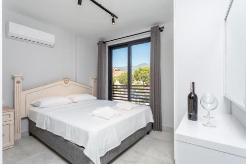 a white bedroom with a bed and a window at Villa Exclusive Paradise 1 in Dalyan