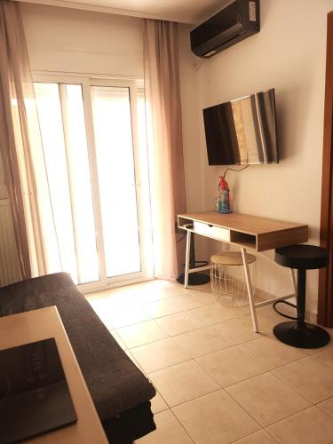 a living room with a desk and a window at Serres Kavafi 7 city center , FREE PARKING in Serres