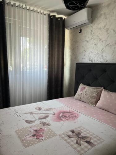 a bedroom with a bed with flowers on it at Lux Cotton in Podgorica