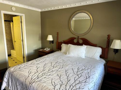 A bed or beds in a room at Western Village Inn