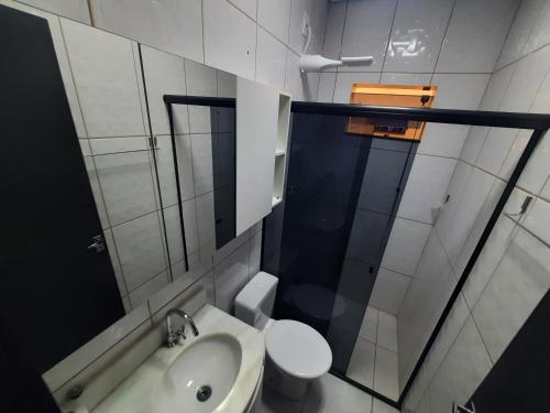 a bathroom with a toilet and a sink and a shower at Ingá Hospedagem in Porto Velho