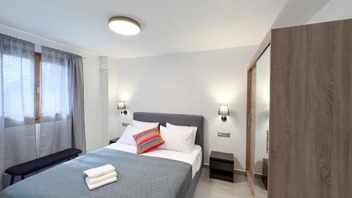 a bedroom with a large bed with a blue blanket at Serenity Villa Batsi in Batsi