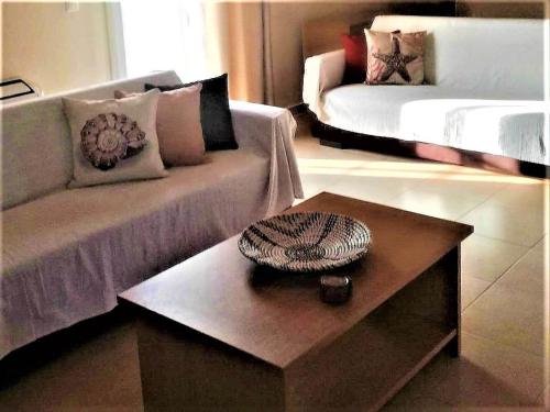 a living room with a couch and a coffee table at VISTA DI MARE 3 in Lixouri
