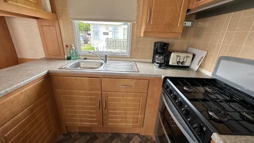 a kitchen with a sink and a stove at Holiday Freedom in Clacton-on-Sea