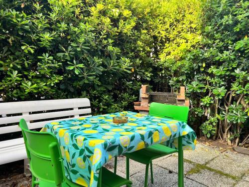 a table and two green chairs with a blue and yellow table cloth at La casa dei sogni in Falconara Marittima