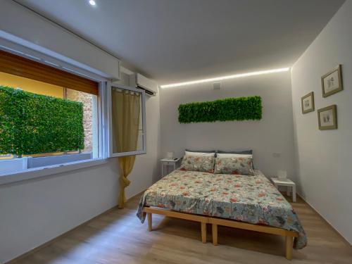 a bedroom with a bed and a window at Il giardino dei portici - Free Air Conditioning - WiFi in Medicina