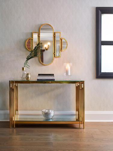 a gold console table with a mirror on a wall at The Glenerin Inn in Mississauga