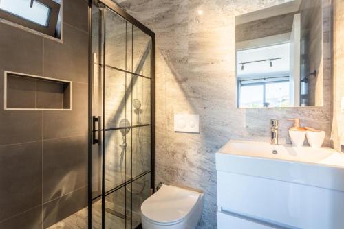 a bathroom with a shower and a toilet and a sink at Villa Exclusive Paradise 2 in Dalyan