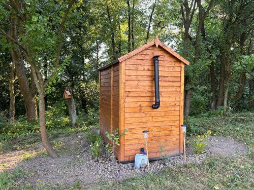 a wooden out house in the middle of a forest at Ubytování Maringote in Doubravice
