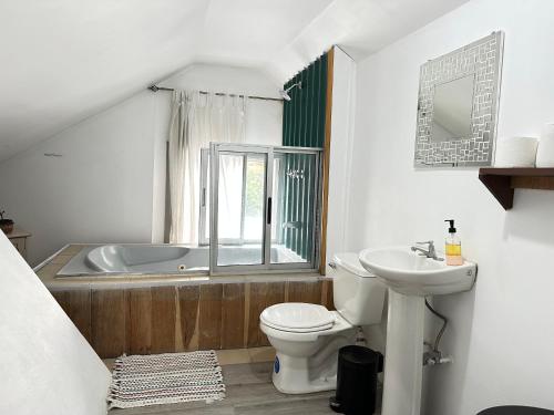 a bathroom with a toilet and a sink and a tub at CASA STELLA in Heredia